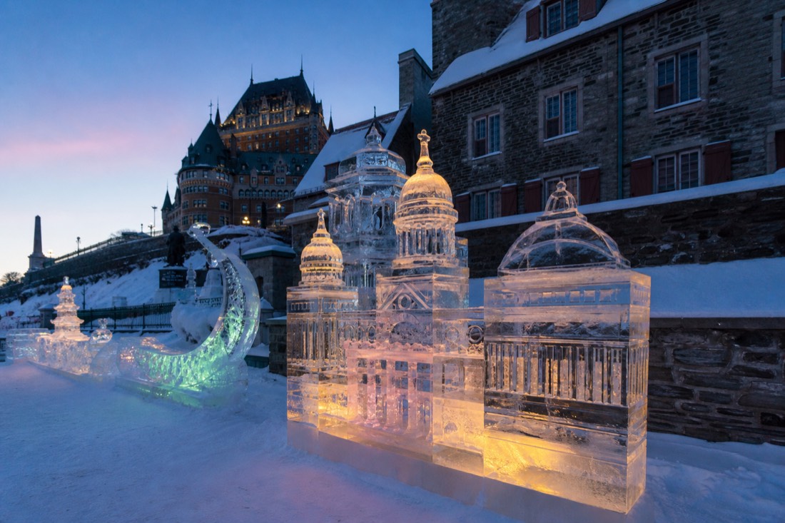 Ice sculptures glowing at dusk during the Quebec Winter Carnival