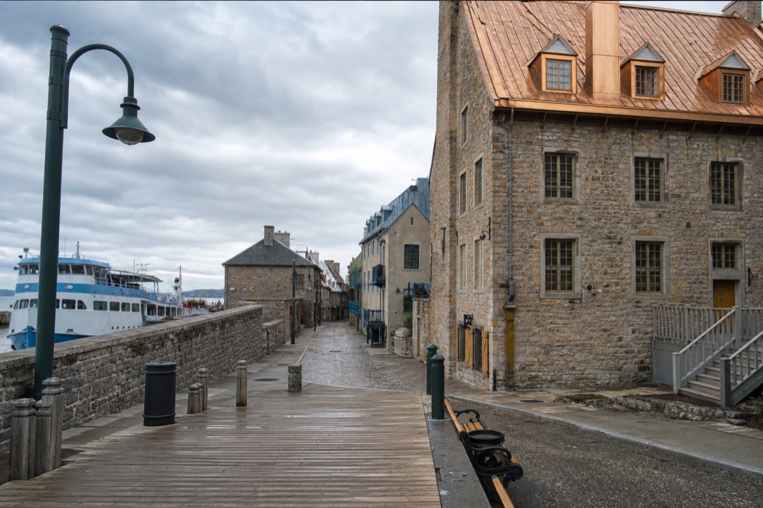 Passengers walking from the Old Port waterfront toward the narrow lanes of the Petit-Champlain district