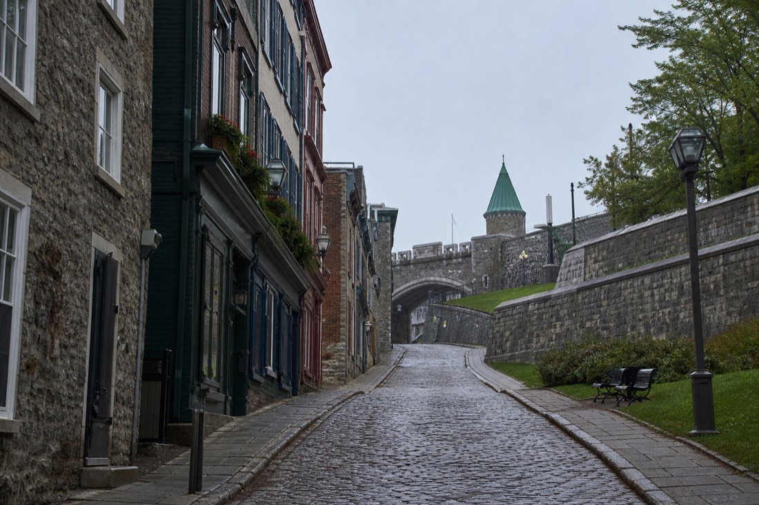 Cobbled street in Old Quebec climbing toward the fortification walls in early morning