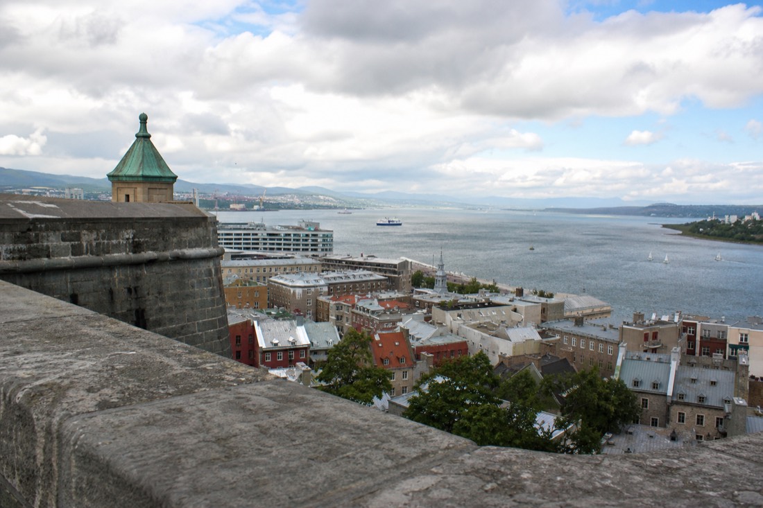 View over Old Quebec rooftops and the St. Lawrence River from the Citadelle ramparts